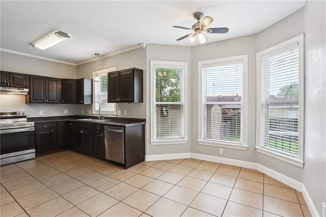 kitchen with dark countertops, appliances with stainless steel finishes, a sink, a ceiling fan, and under cabinet range hood