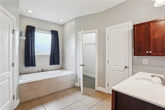 204 Doerr Dr, Arabi, LA 70032 - full bathroom with a garden tub, tile patterned flooring, vanity, a walk in closet, and baseboards