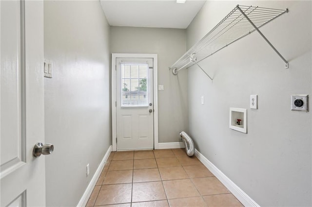 laundry room featuring laundry area, hookup for a washing machine, baseboards, electric dryer hookup, and light tile patterned floors