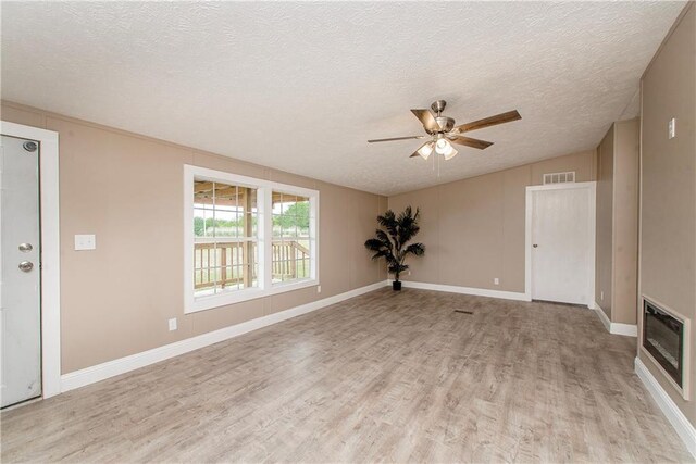 32536 D Wascom Rd, Mount Hermon, LA 70450 - unfurnished living room with a ceiling fan, a textured ceiling, visible vents, and light wood-style flooring