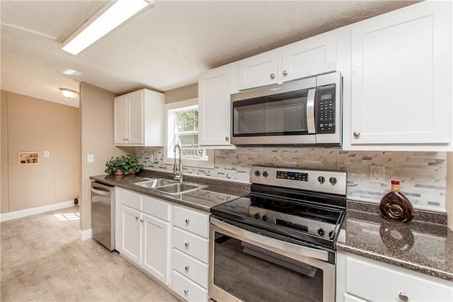 32536 D Wascom Rd, Mount Hermon, LA 70450 - kitchen with backsplash, white cabinets, appliances with stainless steel finishes, and a sink