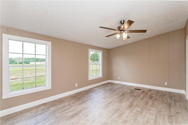 32536 D Wascom Rd, Mount Hermon, LA 70450 - empty room featuring light wood-style floors, a textured ceiling, baseboards, and ceiling fan