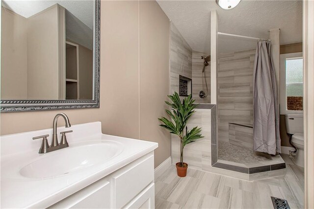 32536 D Wascom Rd, Mount Hermon, LA 70450 - full bath with vanity, visible vents, toilet, tiled shower, and a textured ceiling