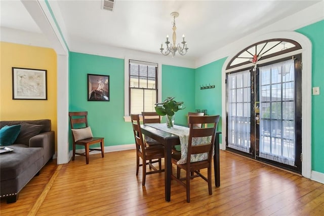 1818 Paul Morphy St, New Orleans, LA 70119 - dining area featuring an inviting chandelier, baseboards, wood-type flooring, and visible vents