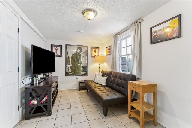 1818 Paul Morphy St, New Orleans, LA 70119 - living area with light tile patterned floors, baseboards, and a textured ceiling