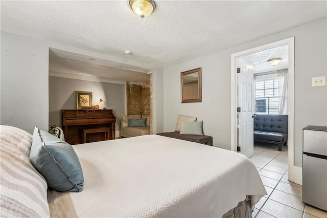 1818 Paul Morphy St, New Orleans, LA 70119 - bedroom with a textured ceiling, freestanding refrigerator, and light tile patterned flooring