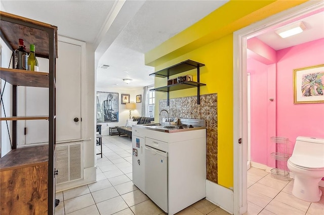 1818 Paul Morphy St, New Orleans, LA 70119 - interior space with visible vents, open shelves, light tile patterned floors, a sink, and white cabinets