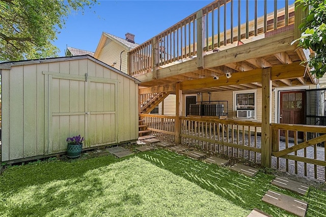 1818 Paul Morphy St, New Orleans, LA 70119 - view of yard featuring a storage shed, a deck, stairway, cooling unit, and an outdoor structure