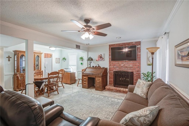 25 Brandon Hall Dr Unit A, Destrehan, LA 70047 - living area with ceiling fan, a textured ceiling, a brick fireplace, ornamental molding, and light tile patterned flooring