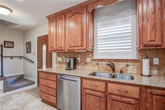 25 Brandon Hall Dr Unit A, Destrehan, LA 70047 - kitchen featuring a sink, dishwasher, brown cabinets, and tasteful backsplash