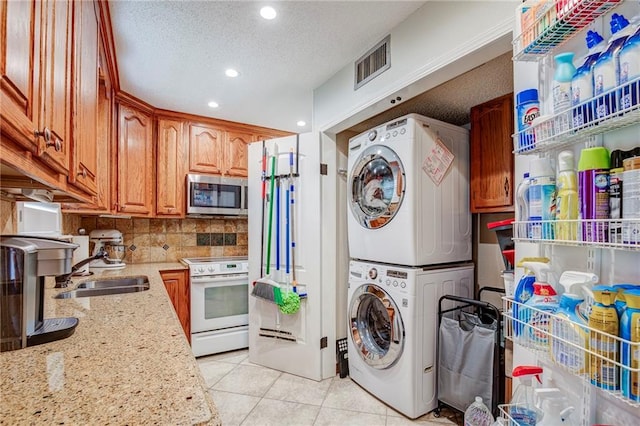 25 Brandon Hall Dr Unit A, Destrehan, LA 70047 - laundry area featuring laundry area, stacked washer / dryer, visible vents, a sink, and recessed lighting
