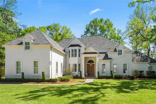 34 Riverdale Dr, Covington, LA 70433 - french country style house featuring a front yard, stucco siding, and roof with shingles