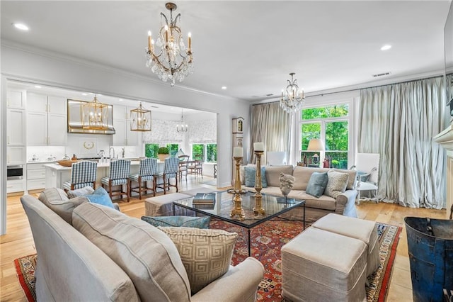 34 Riverdale Dr, Covington, LA 70433 - living area with a chandelier, plenty of natural light, recessed lighting, ornamental molding, and light wood finished floors