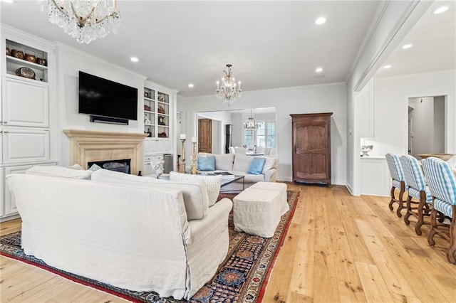 34 Riverdale Dr, Covington, LA 70433 - living room with a chandelier, recessed lighting, light wood-style floors, crown molding, and a tiled fireplace