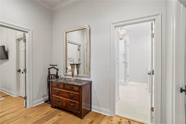 34 Riverdale Dr, Covington, LA 70433 - hallway featuring ornamental molding, baseboards, light wood-style flooring, and a chandelier