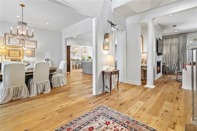 34 Riverdale Dr, Covington, LA 70433 - dining room featuring crown molding, light wood-style flooring, recessed lighting, a chandelier, and a large fireplace