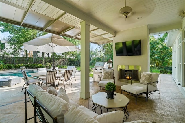 34 Riverdale Dr, Covington, LA 70433 - view of patio featuring an outdoor living space with a fireplace, area for grilling, and fence