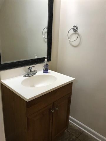 47 Birdie Dr Unit 7, Slidell, LA 70460 - bathroom featuring vanity, baseboards, and tile patterned flooring