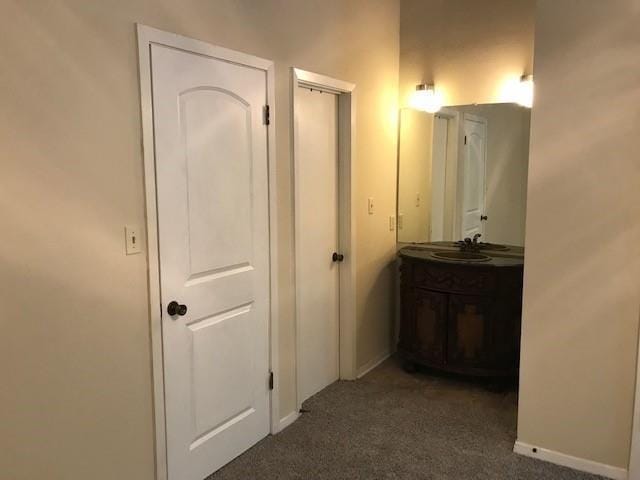 47 Birdie Dr Unit 7, Slidell, LA 70460 - hallway featuring baseboards, a sink, and carpet
