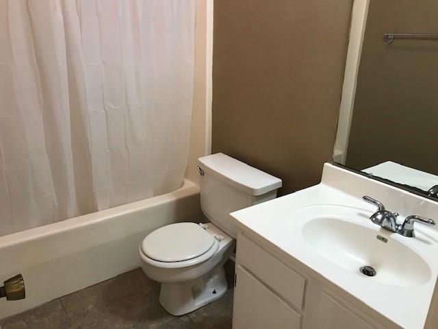 47 Birdie Dr Unit 7, Slidell, LA 70460 - full bathroom featuring toilet, shower / bathtub combination with curtain, and vanity