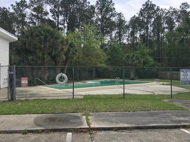 47 Birdie Dr Unit 7, Slidell, LA 70460 - exterior space with a lawn and fence