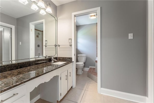 125 Vaccaro St, Independence, LA 70443 - bathroom with toilet, baseboards, tile patterned flooring, walk in shower, and vanity