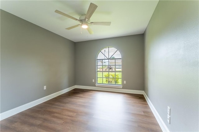 125 Vaccaro St, Independence, LA 70443 - unfurnished room with a ceiling fan, baseboards, and dark wood-type flooring