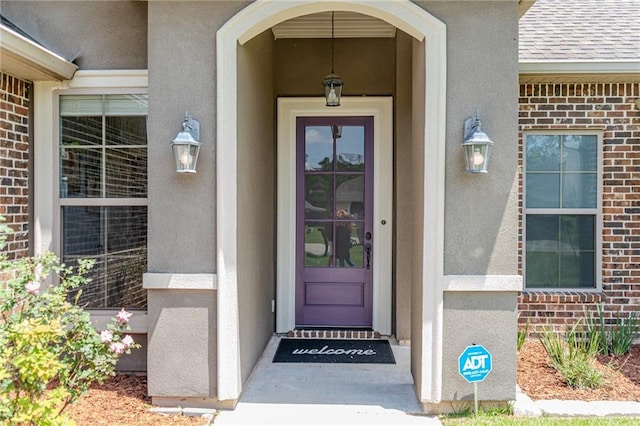 47135 Vineyard Trce, Hammond, LA 70401 - entrance to property with brick siding, roof with shingles, and stucco siding