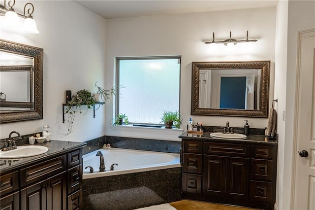 47135 Vineyard Trce, Hammond, LA 70401 - bathroom featuring a garden tub, a sink, and two vanities