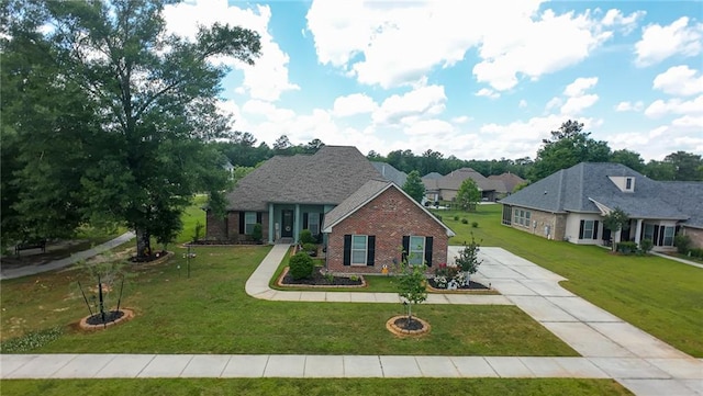 318 Saw Grass Loop, Covington, LA 70435 - view of front of house featuring brick siding, a front yard, and concrete driveway