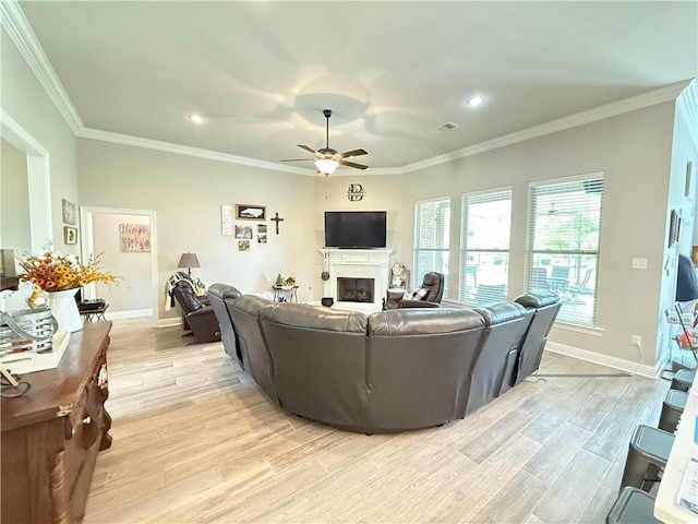 318 Saw Grass Loop, Covington, LA 70435 - living room with ceiling fan, a fireplace, light wood-style flooring, crown molding, and baseboards