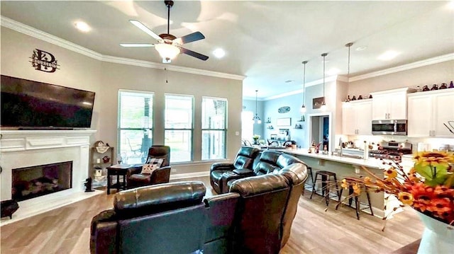 318 Saw Grass Loop, Covington, LA 70435 - living area with ceiling fan, light wood finished floors, ornamental molding, a fireplace, and recessed lighting