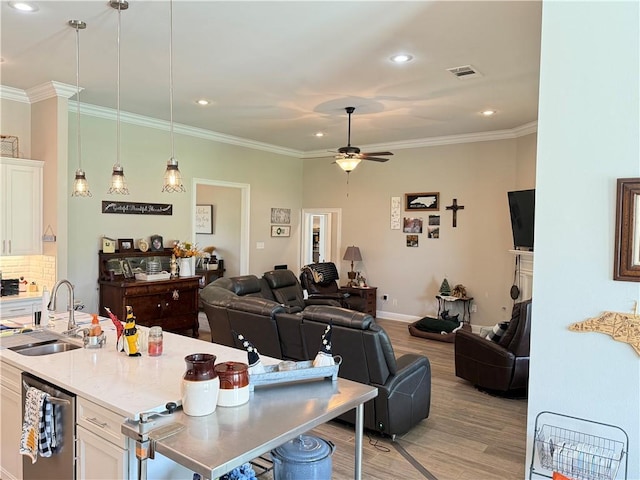 318 Saw Grass Loop, Covington, LA 70435 - kitchen with a sink, white cabinetry, light wood finished floors, open floor plan, and ceiling fan