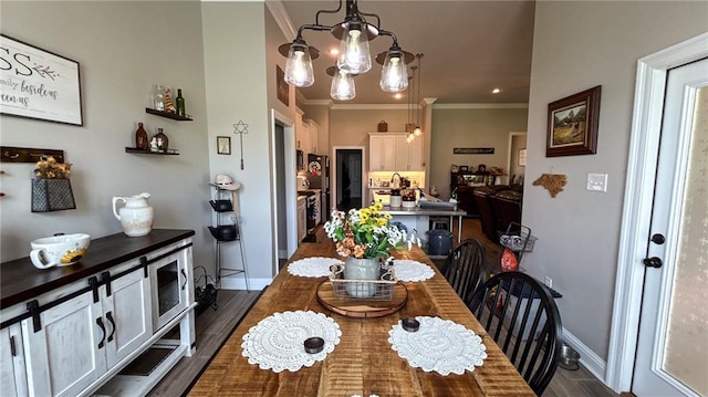 318 Saw Grass Loop, Covington, LA 70435 - dining area with crown molding, baseboards, and a chandelier