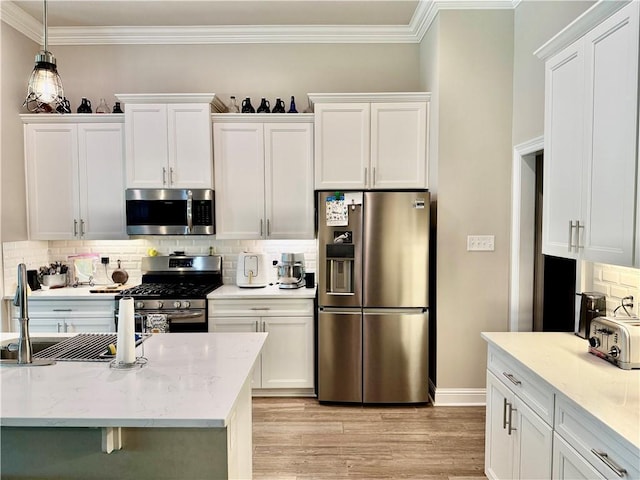318 Saw Grass Loop, Covington, LA 70435 - kitchen featuring stainless steel appliances, ornamental molding, a sink, and white cabinets