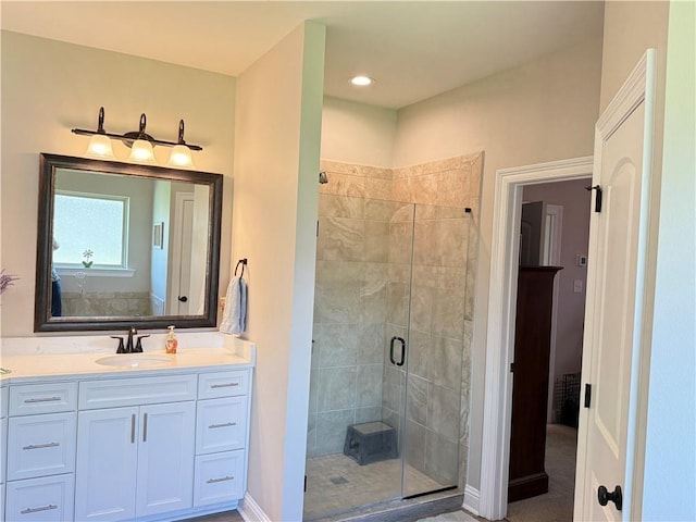 318 Saw Grass Loop, Covington, LA 70435 - bathroom featuring a stall shower, vanity, and baseboards
