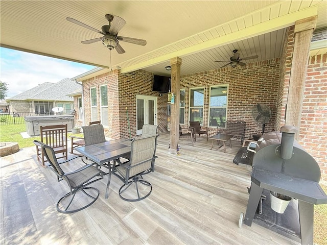 318 Saw Grass Loop, Covington, LA 70435 - deck featuring ceiling fan, a hot tub, outdoor dining area, and fence