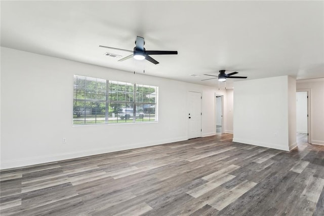 418 E 35th Ave, Covington, LA 70433 - unfurnished living room with baseboards, ceiling fan, visible vents, and wood finished floors