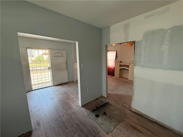 2534 Franklin Ave, New Orleans, LA 70117 - unfurnished room with wood finished floors and a fireplace with raised hearth