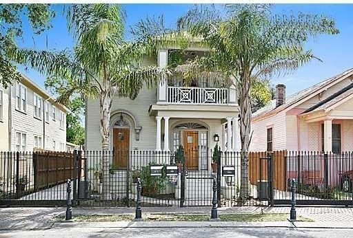 7010 Pritchard Pl Unit A, New Orleans, LA 70125 - view of front of property with a gate, a fenced front yard, a balcony, and covered porch
