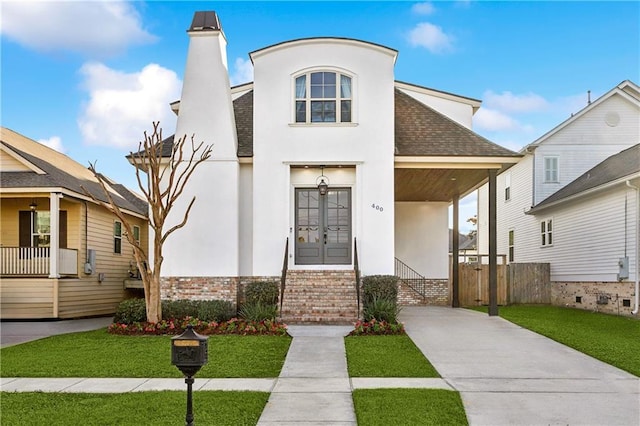 400 40th St, New Orleans, LA 70124 - view of front of home featuring stucco siding, driveway, a chimney, a shingled roof, and brick siding