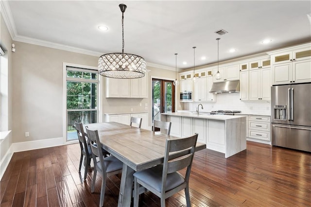 400 40th St, New Orleans, LA 70124 - dining room with plenty of natural light, dark wood-style flooring, baseboards, recessed lighting, and ornamental molding