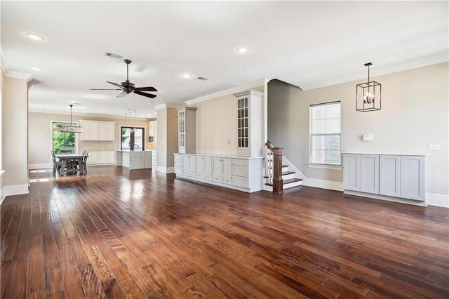 400 40th St, New Orleans, LA 70124 - unfurnished living room with a ceiling fan, dark wood-style floors, crown molding, recessed lighting, and baseboards