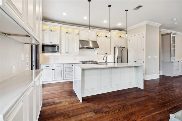 400 40th St, New Orleans, LA 70124 - kitchen featuring stainless steel appliances, under cabinet range hood, ornamental molding, tasteful backsplash, and dark wood-type flooring