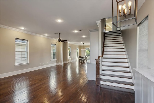 400 40th St, New Orleans, LA 70124 - unfurnished living room with crown molding, a chandelier, dark wood-type flooring, baseboards, and stairway