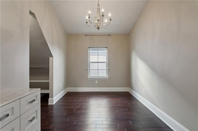 400 40th St, New Orleans, LA 70124 - unfurnished dining area featuring a chandelier, dark wood-style floors, and baseboards