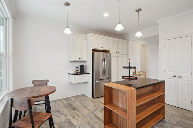 kitchen with crown molding, freestanding refrigerator, open shelves, and dark countertops
