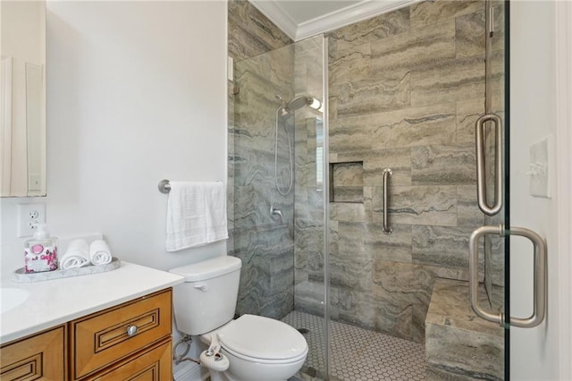 bathroom featuring vanity, ornamental molding, a stall shower, and toilet