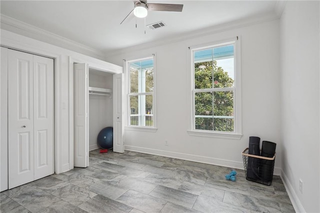 unfurnished bedroom with visible vents, crown molding, two closets, baseboards, and ceiling fan