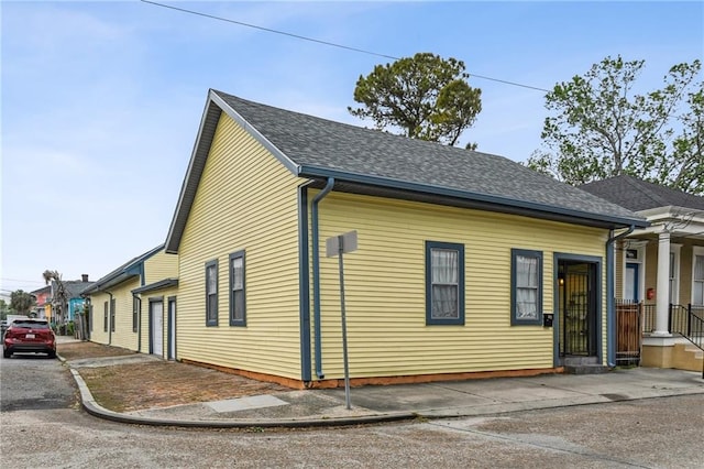 3031 Annunciation St, New Orleans, LA 70115 - view of property exterior featuring roof with shingles